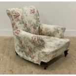 A Victorian upholstered armchair, turned front supports moving on castors. H77cm