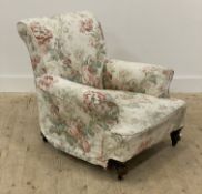 A Victorian upholstered armchair, turned front supports moving on castors. H77cm