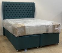 A contemporary 4'5" queen bed, with a deep buttoned upholstered headboard, divan base moving on