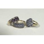 A 9ct gold QVC navette shaped lavender coloured stone cluster ring, M, a 9ct gold QVC triple row