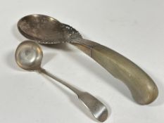 A Eastern white metal horn handled serving spoon with scrolling engraved pierced dragon sides and