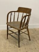 A late 19th century ash and oak elbow chair, the curved crest rail and bentwood arms above a spindle