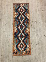A Chobi kilim runner rug of typical geometric design 195cm x 60cm