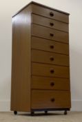Schrieber, A mid century teak veneered tall chest, fitted with eight graduated drawers, moving on