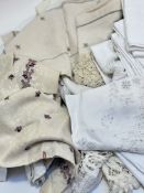 A large collection of various table linens, scalloped napkins, hand stitched linens and various