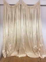 A pair of lined satinized curtains with fleur de lis motif, drop 260cm, W287cm (some staining)