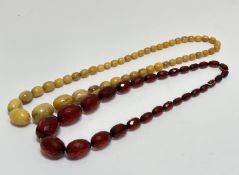 A vintage 1920's faux amber graduated graduated bead necklace, (L x 28cm) and a red faceted faux