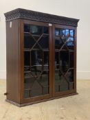 A George III mahogany wall hanging display cabinet, the dentil cornice over blind fret frieze and