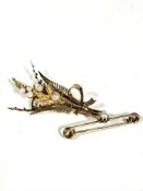 A Edwardian 9ct gold fern and leaf spray brooch set seed pearls, (L x 5.5cm) and a yellow metal