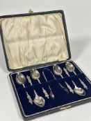 A Birmingham set of six silver Apostle tea spoons and matching pair of tongs in original fitted