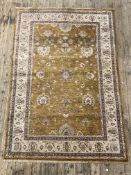 A hand knotted Ziegler type carpet, the abrashed yellow field with flower head motif within a