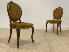 A pair of Victorian rosewood framed drawing room chairs, with floral carved crest rail above a