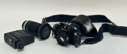 A Nikon EM camera with a Lens series E 50mm 1:1.8 lens and case, a Hoya HMC Zoom 70-150mm lens and a