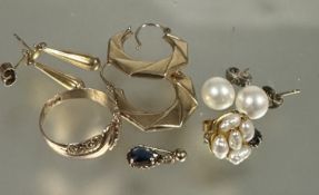 A collection of pierced earrings including pearl studs, yellow metal fluted tear drop earrings,