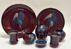 A collection of jun glazed studio pottery comprising two mugs (h-11cm), a candle holder (h-4cm), a