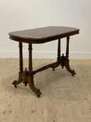 A Victorian walnut stretcher table the top with bowed ends raised on cluster column and splayed