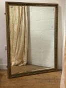 A large gilt composition framed wall mirror with bevelled plate 102cm x 132cm