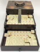 A late nineteenth/early twentieth century Chinese Mahjong travel set comprising a quantity of bone/