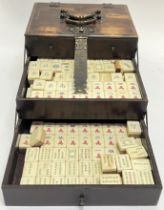 A late nineteenth/early twentieth century Chinese Mahjong travel set comprising a quantity of bone/