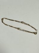 A 18ct gold triple chain and ball pattern bracelet, (L x 19cm) 3.6g