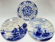 A pair of blue and white Delft style dishes/chargers with Dutch windmill and sailing scenes (