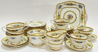 A Paragon China part tea/dessert service decorated with floral sprays comprising six cups, twelve