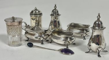 A Birmingham five piece condiment set comprising, a pair of oval salt sellers, a pair of pepperettes