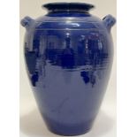 A large twin-handled blue glazed pottery storage jar (label verso 'Inscape') (h- 38cm, w- 30cm)