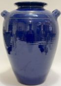 A large twin-handled blue glazed pottery storage jar (label verso 'Inscape') (h- 38cm, w- 30cm)