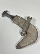 A Omani white metal mounted khanjar, of characteristic form, with shaped horn handle, the scabbard