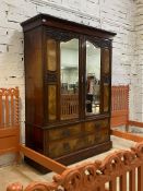 A late Victorian walnut and mahogany wardrobe, the egg and dart moulded cornice above two bevel