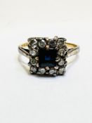A 9ct gold sapphire and twelve stone diamond set ring with cushion cut sapphire to centre and