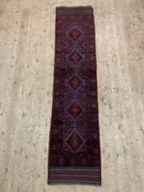 A Meshwani runner rug, the field with multiple lozenges and bordered 257cm x 60cm