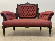 A Victorian Aesthetic period ebonised drawing room sofa, the show frame inscise carved and parcel