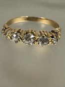 A yellow metal ring set five graduate old mine cut diamonds mounted in claw setting, K/L, centre