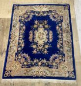 A Chinese super washed wool carpet, the blue field characteristically decorated 244cm x 330cm