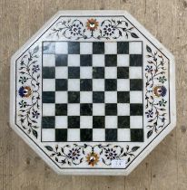 A Pietra Dura style conglomerate white marble chess board of octagonal outline, inlaid with green