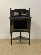 A Victorian aesthetic movement ebonised and parcel gilt floor standing corner cabinet, the raised