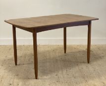 A mid century teak and beech dining table, the draw leaf with leaf housed under, raised on tapered