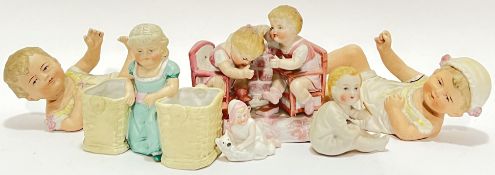 A mixed lot of bisque ceramics comprising two reclining infant child models (w- 15cm) (one broken