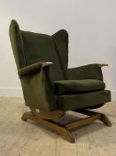 A 1930's / 1940's green velvet upholstered wing back rocking chair H93cm