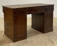 A Victorian mahogany twin pedestal writing desk, the top inset with tooled skiver, above three