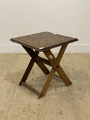 A Victorian oak games table, the lift off parquetry top raised on a folding base of crossed form