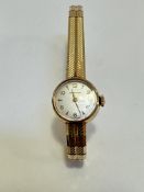 A lady's Certina 9ct gold wristwatch, the silvered dial with baton and Arabic numerals on flexible