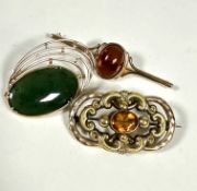 A modern 9ct gold oval Nephritic Jadeite brooch set in radiating open setting, (L x 4cm), a 9ct gold