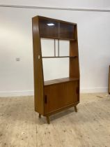 A mid century teak open wall shelf or room divider, twin sliding glass doors over two open shelves