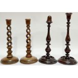 A pair of twist-stem oak candlestick holders (h- 31cm), together with a pair of mahogany candlestick