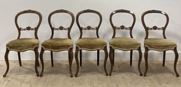 A set of five Victorian carved walnut framed dining chairs, the upholstered seats raised on cabriole