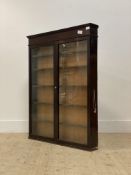 A 19th century mahogany wall hanging cabinet, the two glazed doors enclosing five fixed shelves