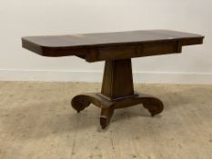 A Regency bleached mahogany library table, the rectangular top with projecting ends above a drawer